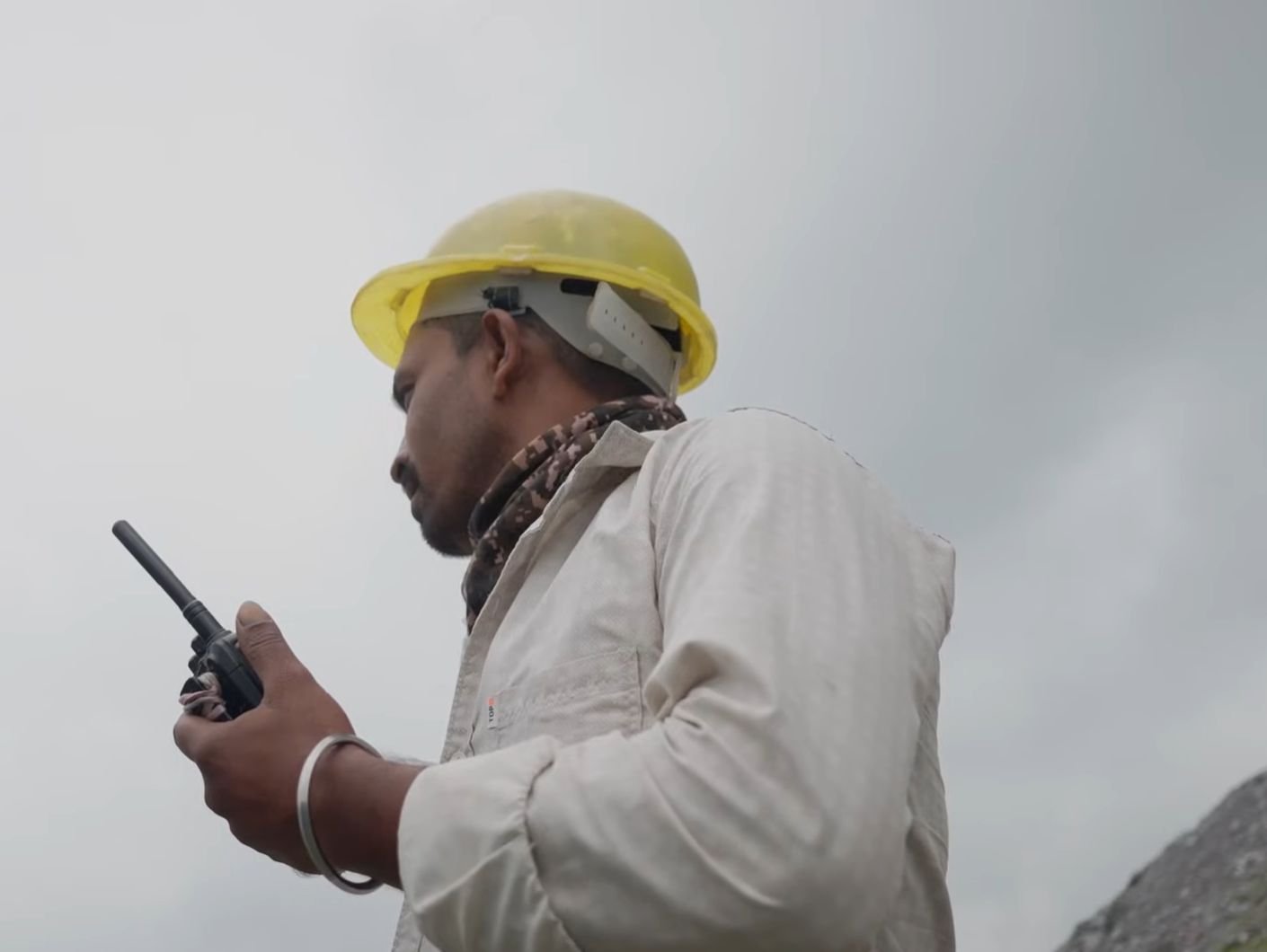 Site supervisor coordinating operations by radio