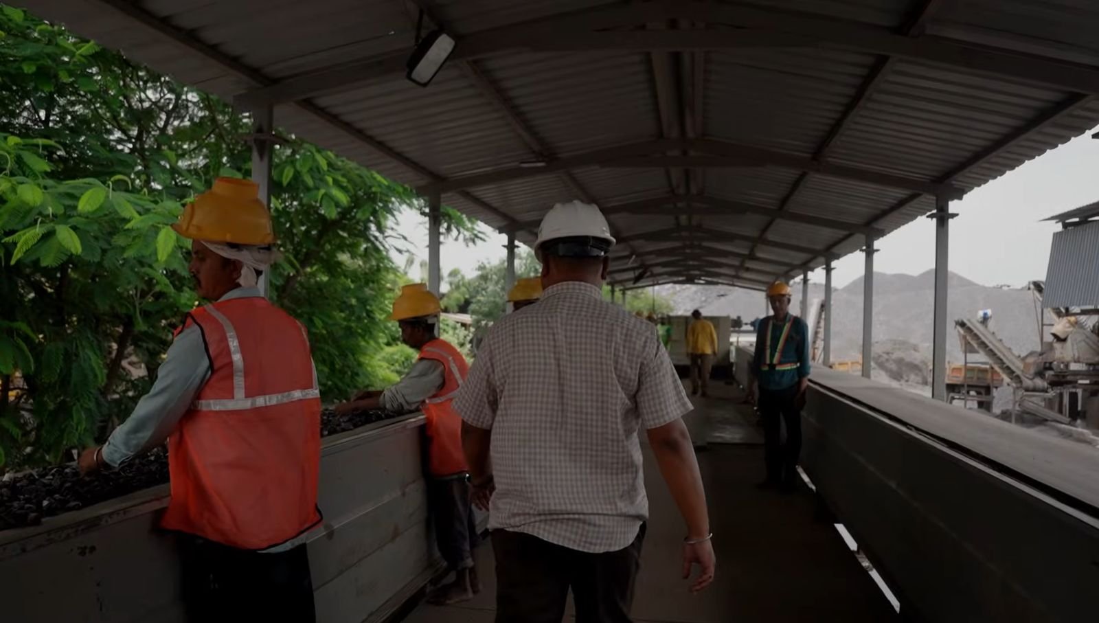 Supervisor walking the ore sorting line