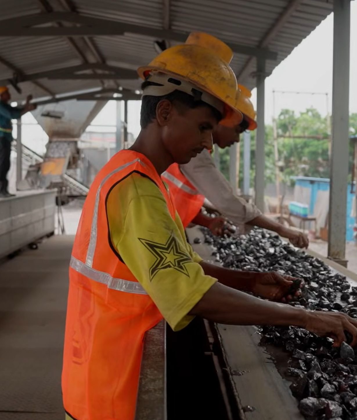 Hand-sorting manganese ore on the picking belt